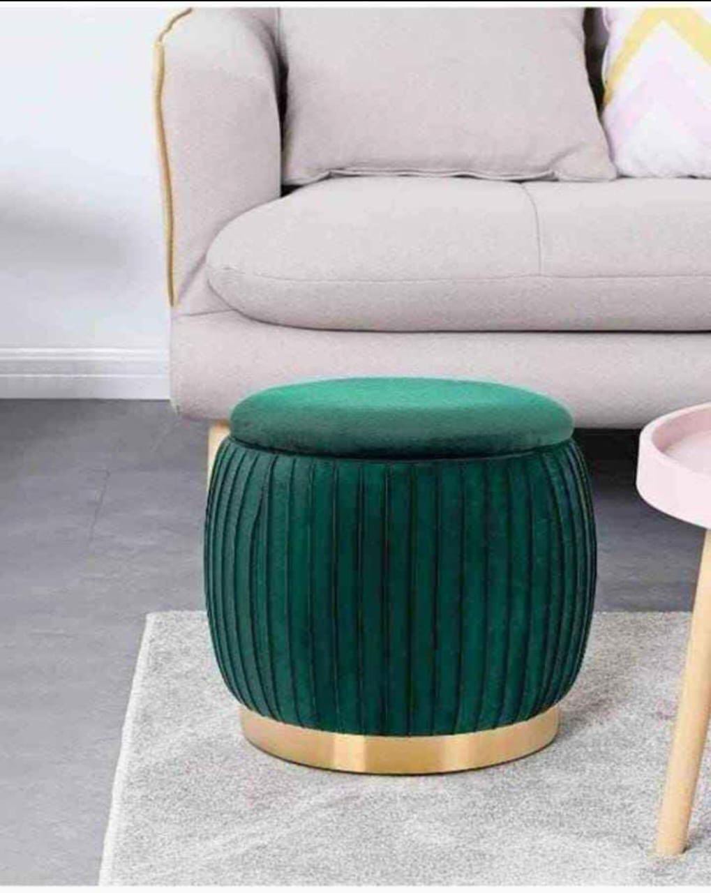 Luxury velvet storage ottoman stool with gold base trim used as footrest and storage seat