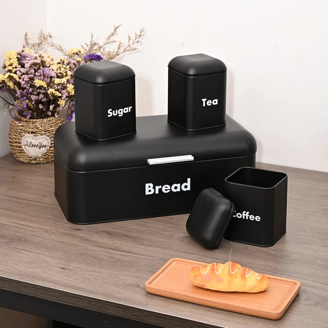 Black alloy bread bin with three matching kitchen canisters for countertop storage