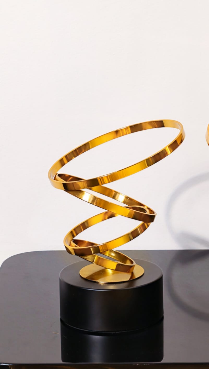 Gold swirl abstract sculpture, modern decorative accent for home or office décor.