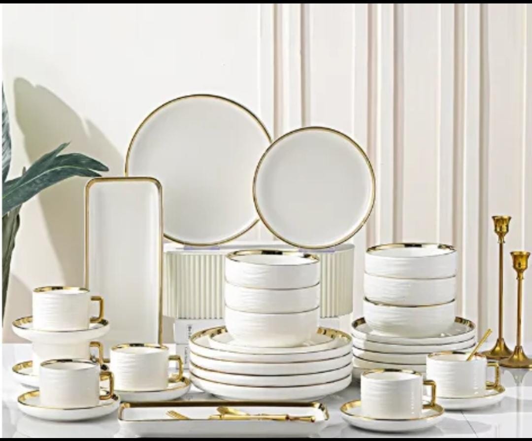 32-piece dinner set with gold-edged striped design, including plates, bowls, and serving pieces