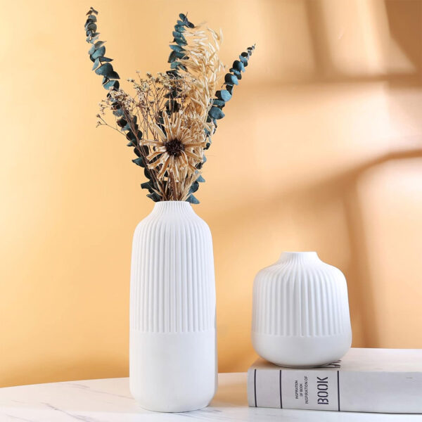 Set of two white ceramic vases with ribbed design, large 24.5×11 cm and small 14×13.5 cm, ideal for flowers or standalone decor.