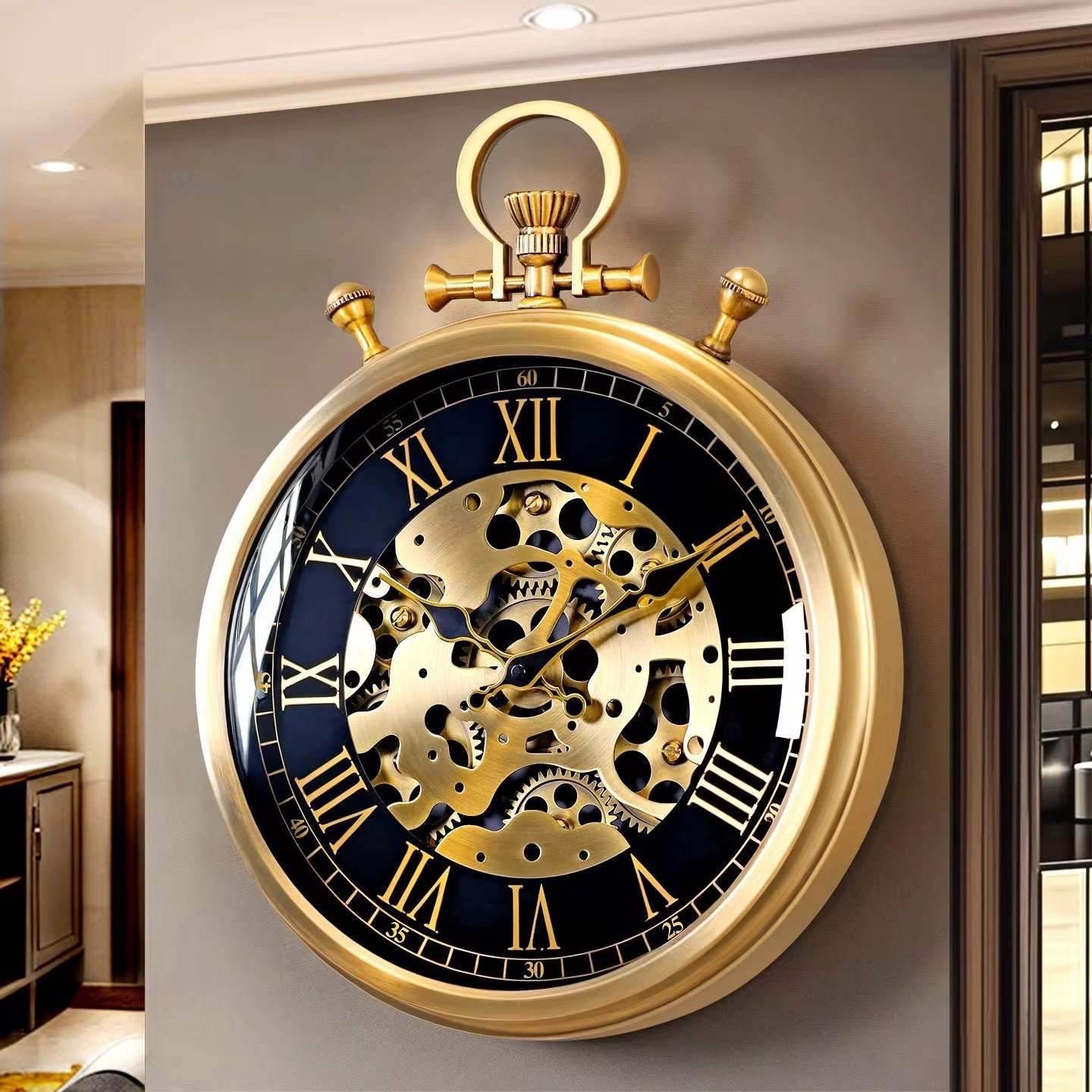 Oversized black and gold round wall clock with Roman numerals, exposed decorative moving gears, and a gold-tone metal frame mounted on a wall.