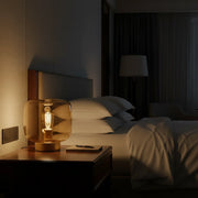 table lamp with amber glass shade and gold finish for warm ambient lighting