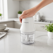 Philips Daily Collection HR1393 mini food chopper with 0.7L plastic bowl and stainless steel double blades.