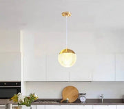 Dawood Lifestyle & Gadgets kes gold crystal globe pendant light featuring a textured clear glass sphere, luxury gold metal cap, and elegant ceiling-mounted design for modern and contemporary interiors.