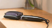 Dawood Lifestyle & Gadgets ke Philips ThermoProtect heated straightening brush with tourmaline ceramic coating and two temperature settings designed for fast hair straightening smooth styling and shiny frizz free results.