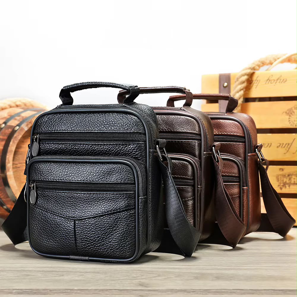 Unisex leather crossbody bag with multiple zipped compartments in black and brown