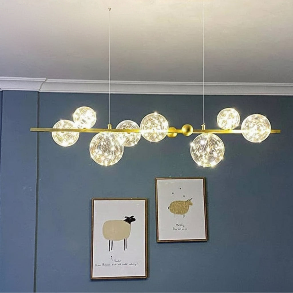 Dawood Lifestyle & Gadgets kes 8-bubble linear chandelier featuring crackled glass globes with fairy lights, polished gold bar frame, and luxury ceiling-mounted design for dining rooms and modern interiors.