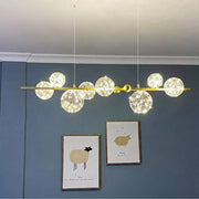 Dawood Lifestyle & Gadgets kes 8-bubble linear chandelier featuring crackled glass globes with fairy lights, polished gold bar frame, and luxury ceiling-mounted design for dining rooms and modern interiors.