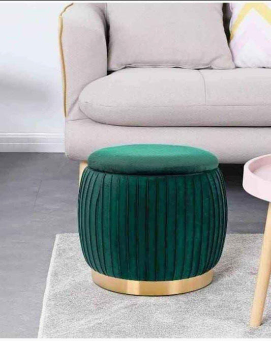 Luxury velvet storage ottoman stool with gold base trim used as footrest and storage seat