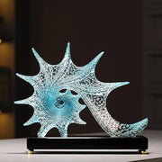 Blue resin conch seashell decorative sculpture with sparkling textured finish for elegant home décor.