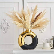 Black and gold donut-shaped flower vase for modern home décor and table centerpiece. 🌸✨