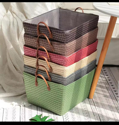 Handheld woven basket organizer for laundry, clothing, toys, and home storage.