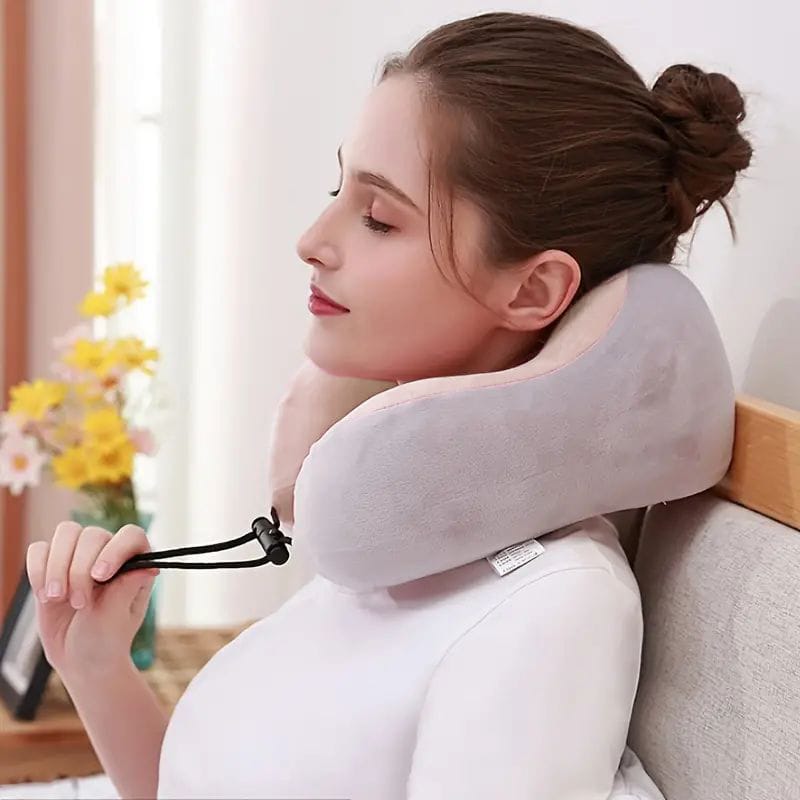 Portable U-shape neck pillow massager with heat and vibration, ergonomic design for cervical spine relaxation and relief. 