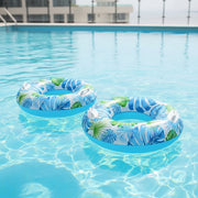 Tropical inflatable swim tube with leaf print and handles for beach and pool floating
