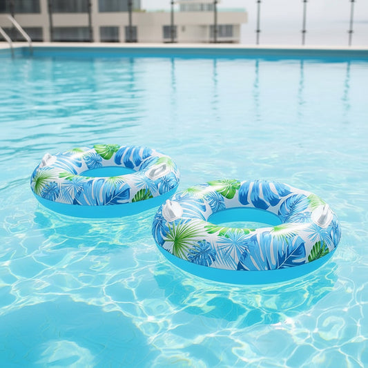 Tropical inflatable swim tube with leaf print and handles for beach and pool floating
