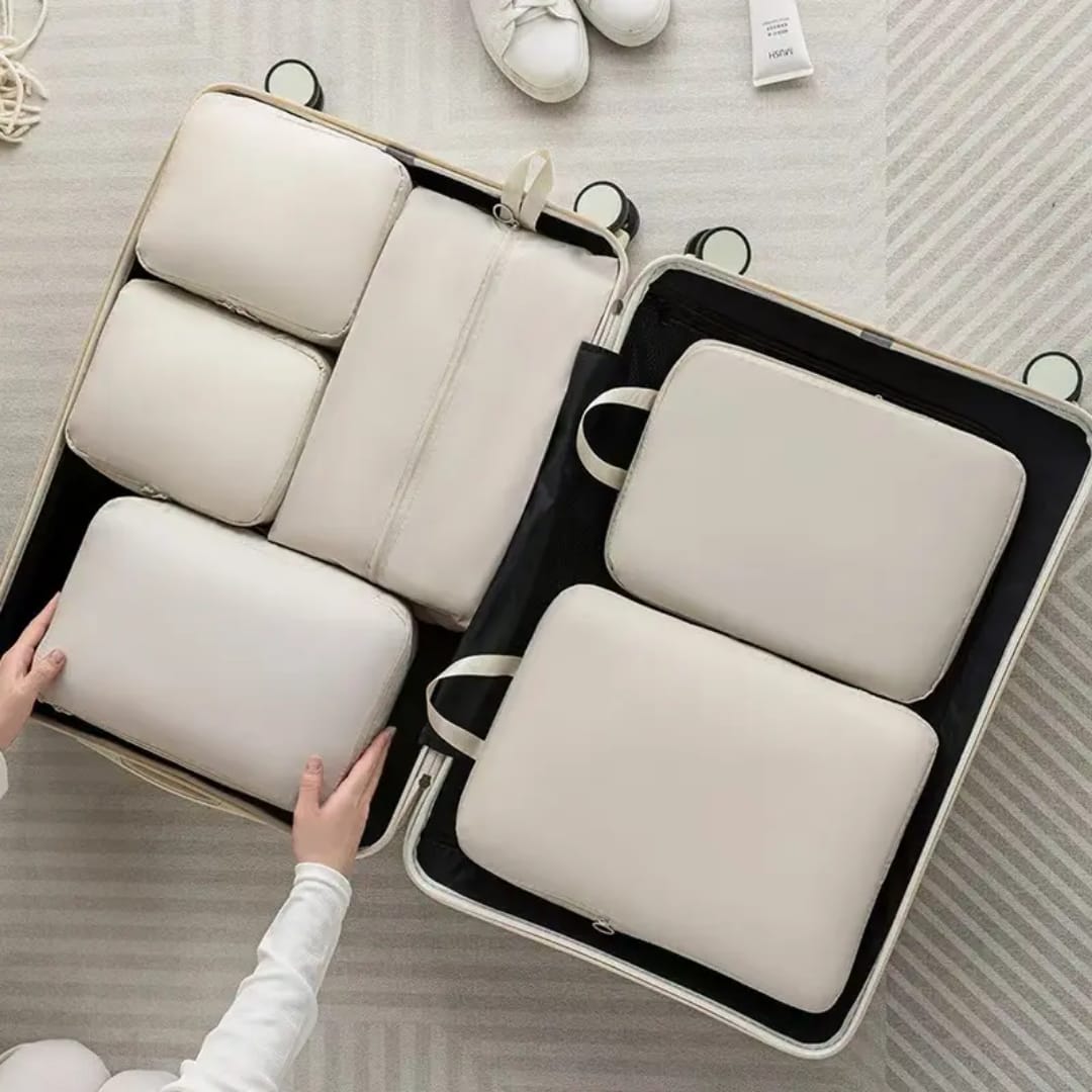 6-piece compressible waterproof luggage travel bags in beige, light blue, and pink