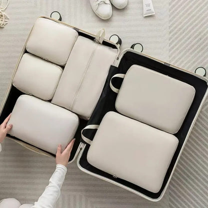 6-piece compressible waterproof luggage travel bags in beige, light blue, and pink