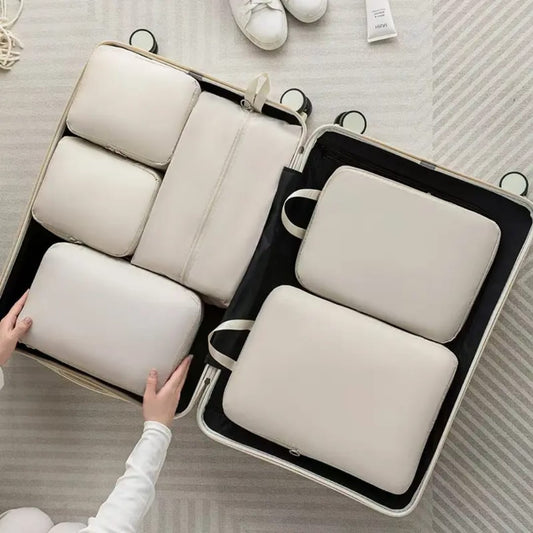 6-piece compressible waterproof luggage travel bags in beige, light blue, and pink