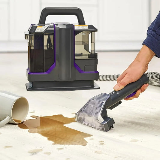 Handheld wet and dry fabric cleaner with double head stain removal system for sofas, carpets, and upholstery. 