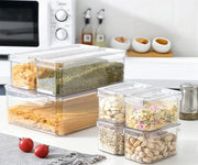 7 piece acrylic stackable fridge organiser set with clear storage bins for fruits vegetables drinks snacks and refrigerator food organisation in multiple sizes.