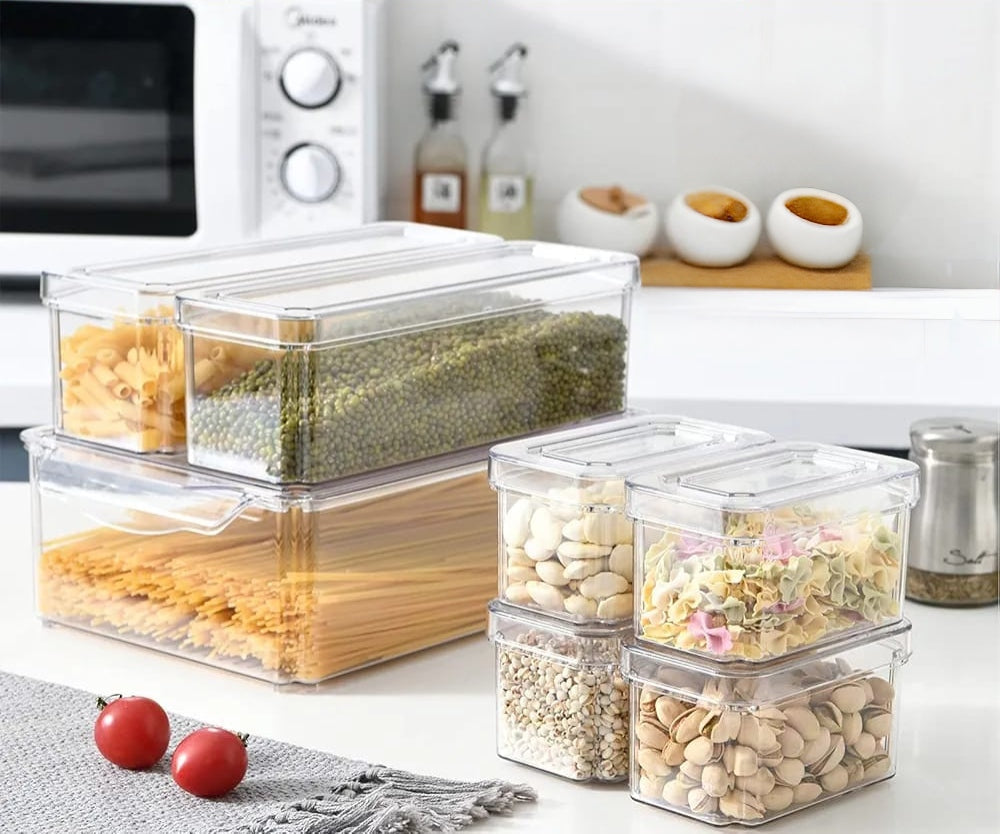 7 piece acrylic stackable fridge organiser set with clear storage bins for fruits vegetables drinks snacks and refrigerator food organisation in multiple sizes.