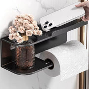 Wall mounted metal toilet paper holder with storage shelf for bathroom organization and modern décor.