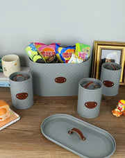 4-piece quilted metal bread bin and canister set with airtight lids, rope handle, and labeled coffee, sugar, and tea containers for stylish kitchen storage.