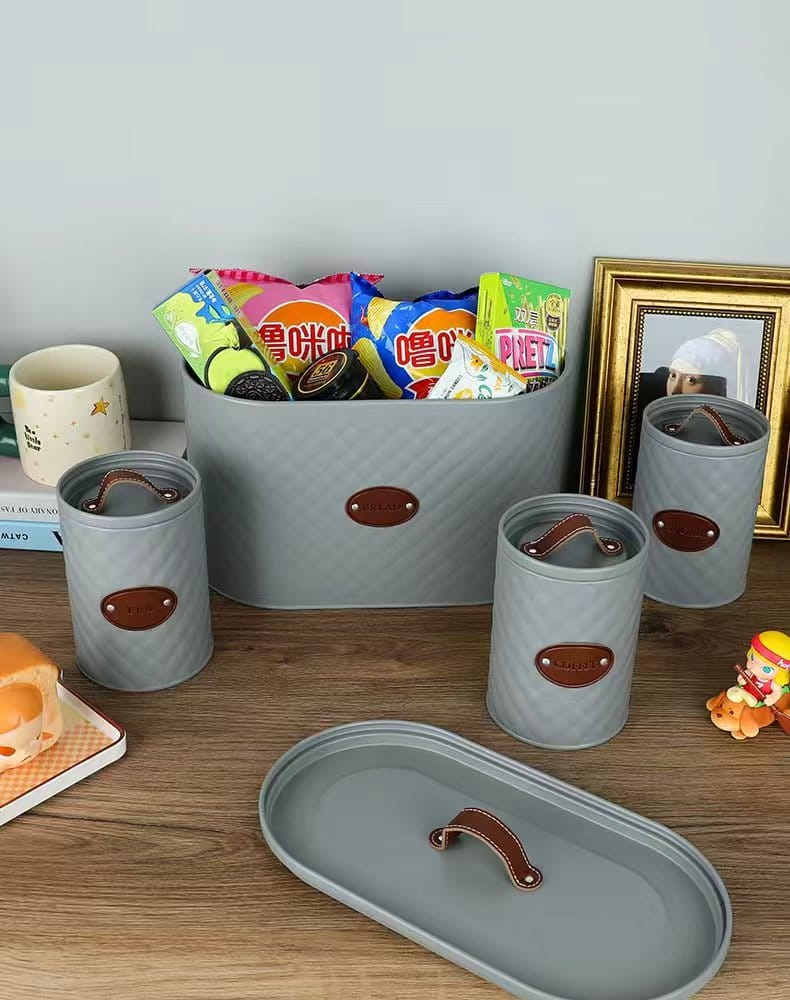 4-piece quilted metal bread bin and canister set with airtight lids, rope handle, and labeled coffee, sugar, and tea containers for stylish kitchen storage.