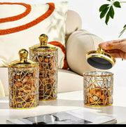 Set of three square transparent acrylic storage jars with gold lines
