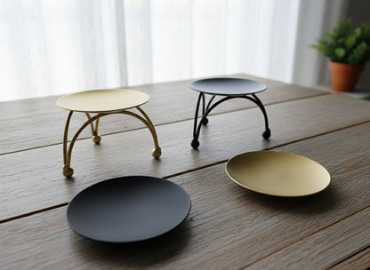 Small decorative candle holder in gold and black colors.