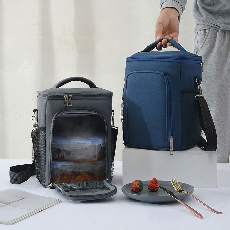 Insulated two-compartment lunch bag with crossbody strap.