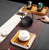 Cast iron tea pot with infuser, cast iron coaster and spoon