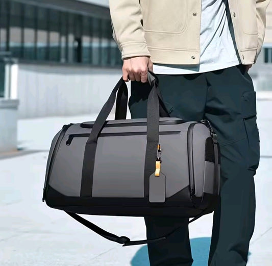 Durable duffle bag with separate shoe compartment available in black and grey for travel and gym use.