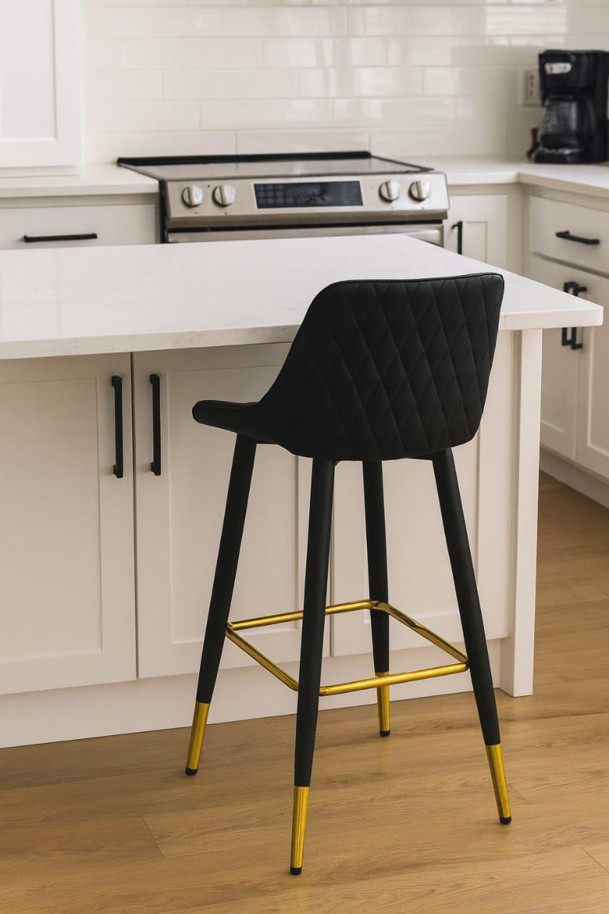 Modern counter stool with golden footrest and PU leather seat.
