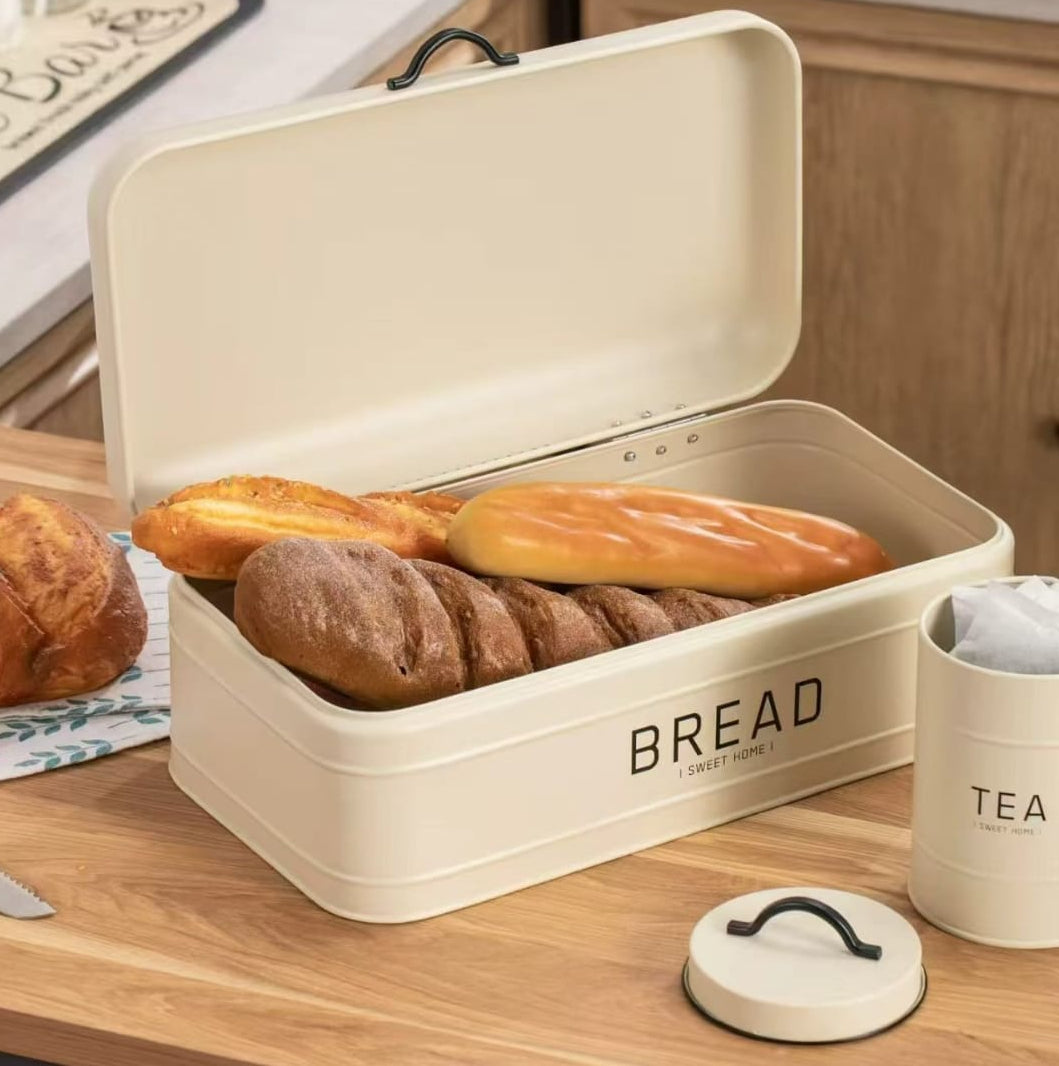 4 piece quilted metal bread box and canister set with airtight lids, including labelled coffee, sugar, and tea containers.