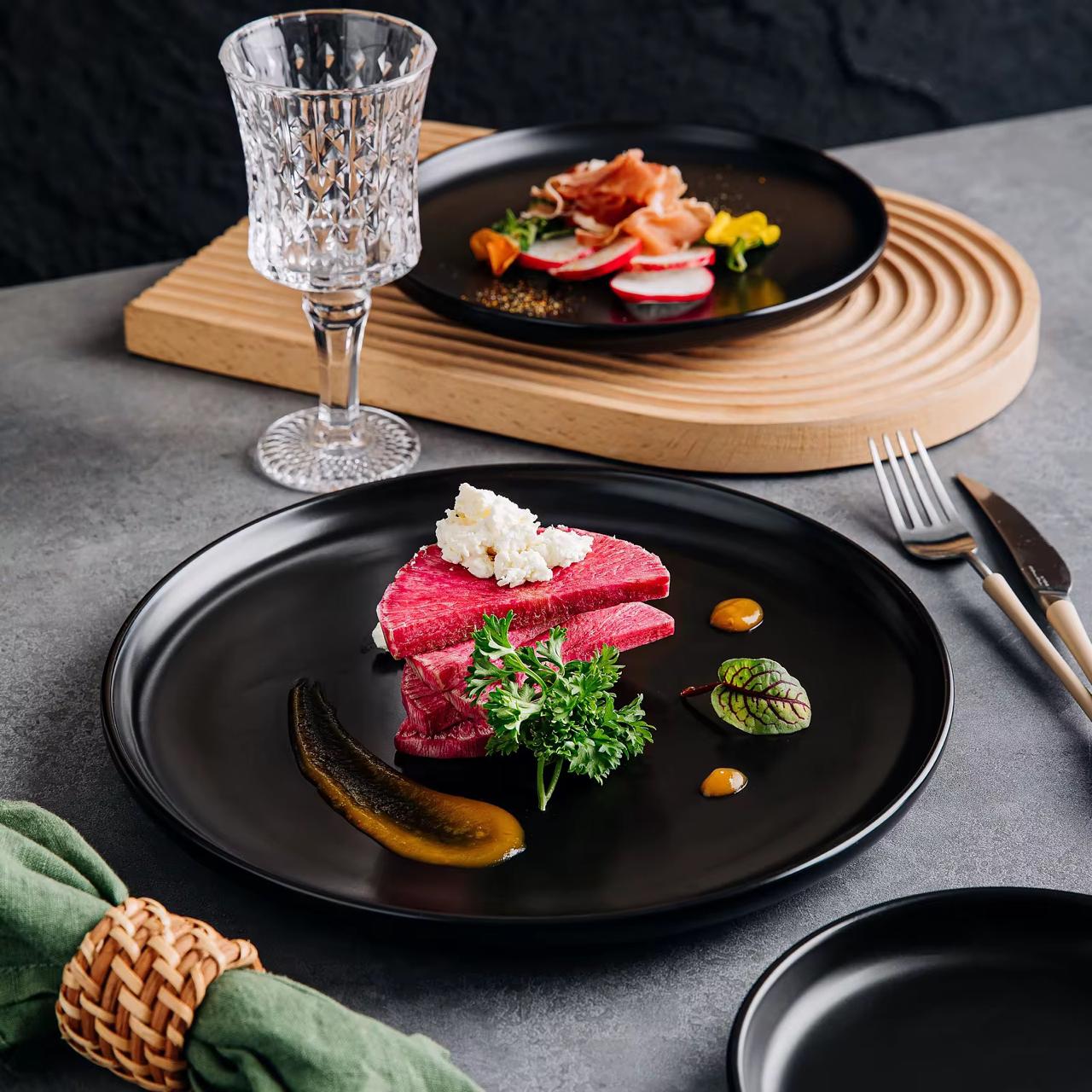 Matte black 10.5 inch dinner plate with bordered design.