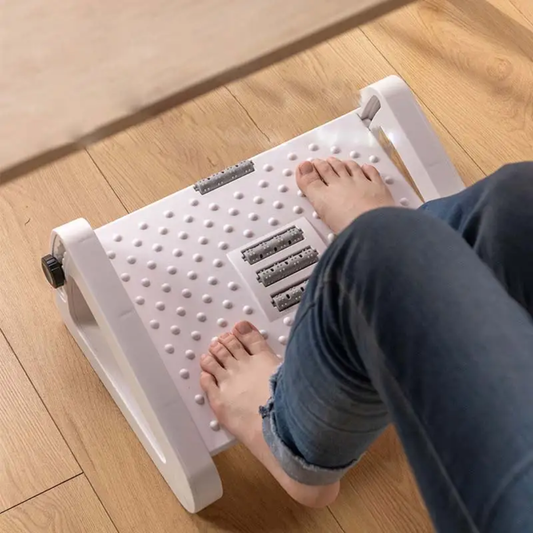 White ergonomic adjustable under-desk foot rest with massage rollers