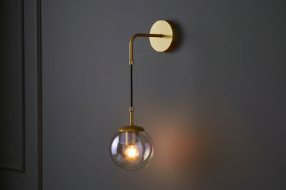 Golden curved arm wall lamp with clear glass shade, elegant E27 decorative indoor lighting fixture