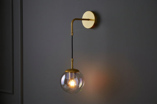 Golden curved arm wall lamp with clear glass shade, elegant E27 decorative indoor lighting fixture