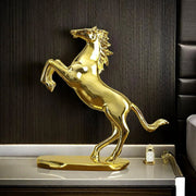 Dawood Lifestyle & Gadgets kes golden rearing horse statue with mirror gold finish, detailed flowing mane and tail, mounted on an oval base for luxury home and office décor.
