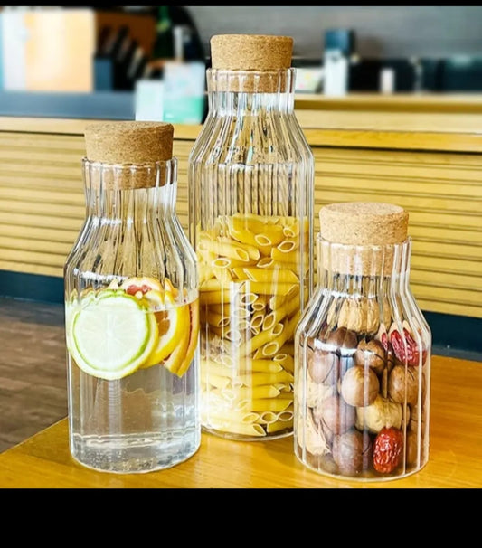 Clear ribbed borosilicate glass storage jar with acacia wooden cork lid.