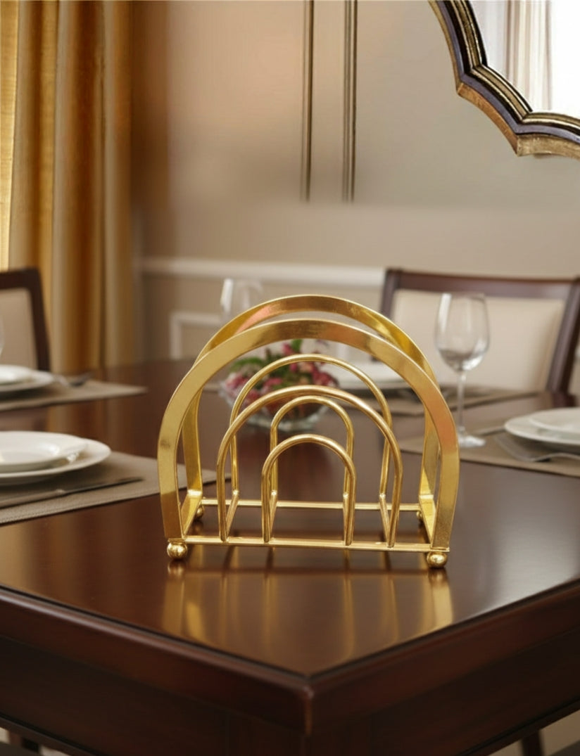 Gold heavy duty serviette napkin holder on table.