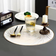 Set of six luxury round PVC placemats with a swirl firework compass pattern, heat resistant and washable, available in silver and gold.