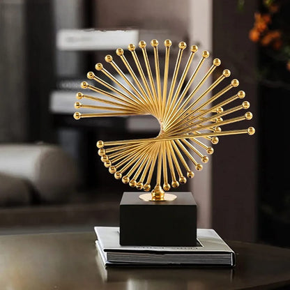Gold abstract metal sculpture with black base measuring 26 × 24 cm for home or office décor