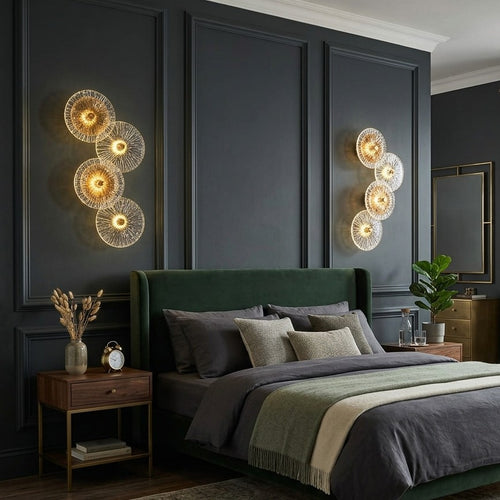 Modern wall-mounted decorative light fixture with four illuminated textured circular discs and warm golden glow. 