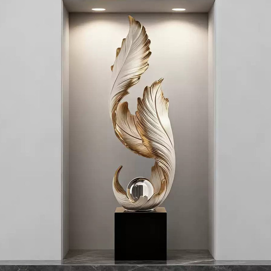 Elegant white and gold resin feather sculpture with a crystal ball accent for luxury home and office décor.