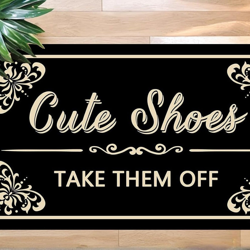 Non-slip black doormat with cream-colored message, suitable for indoor and outdoor use, size 50×80 cm