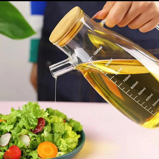 1L Heat-resistant glass oil dispenser with bamboo lid and handle for kitchen use.