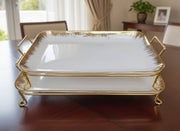 Two-piece ceramic serving tray set with gold stand for snacks and desserts.